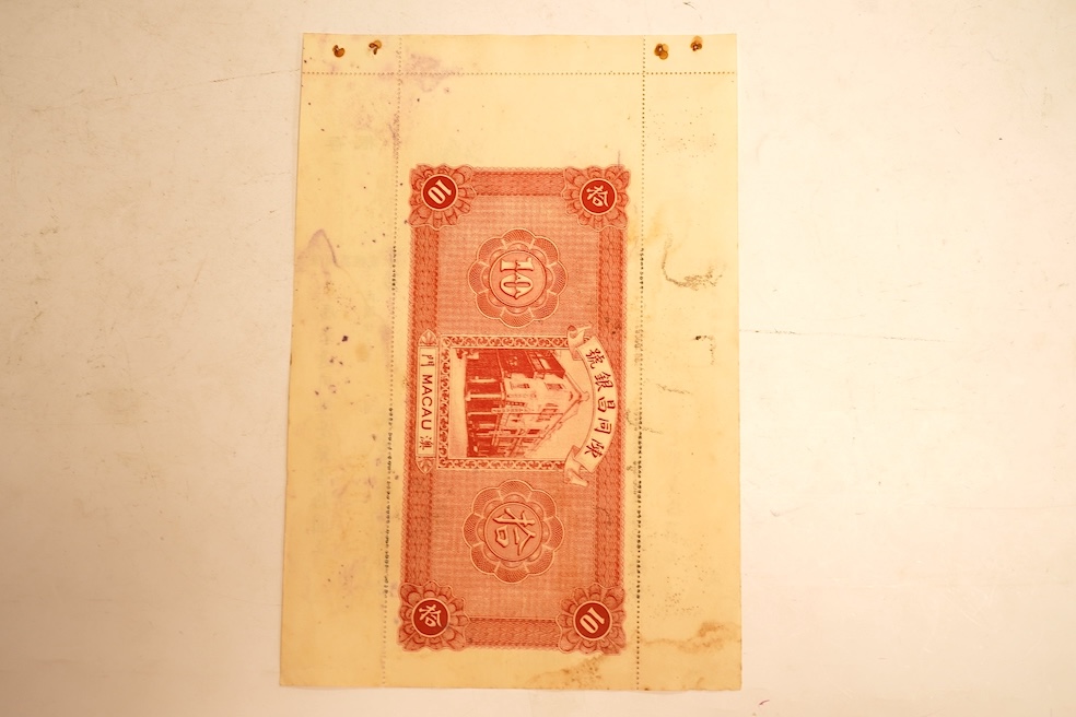 Macau Chan Tung Cheng Bank 1934 10 Yuan banknote, unissued remainder, with original perforated counterfoils. Issued for trade purposes during the Portuguese occupation of Macau. Typical staple holes and light ink blottin